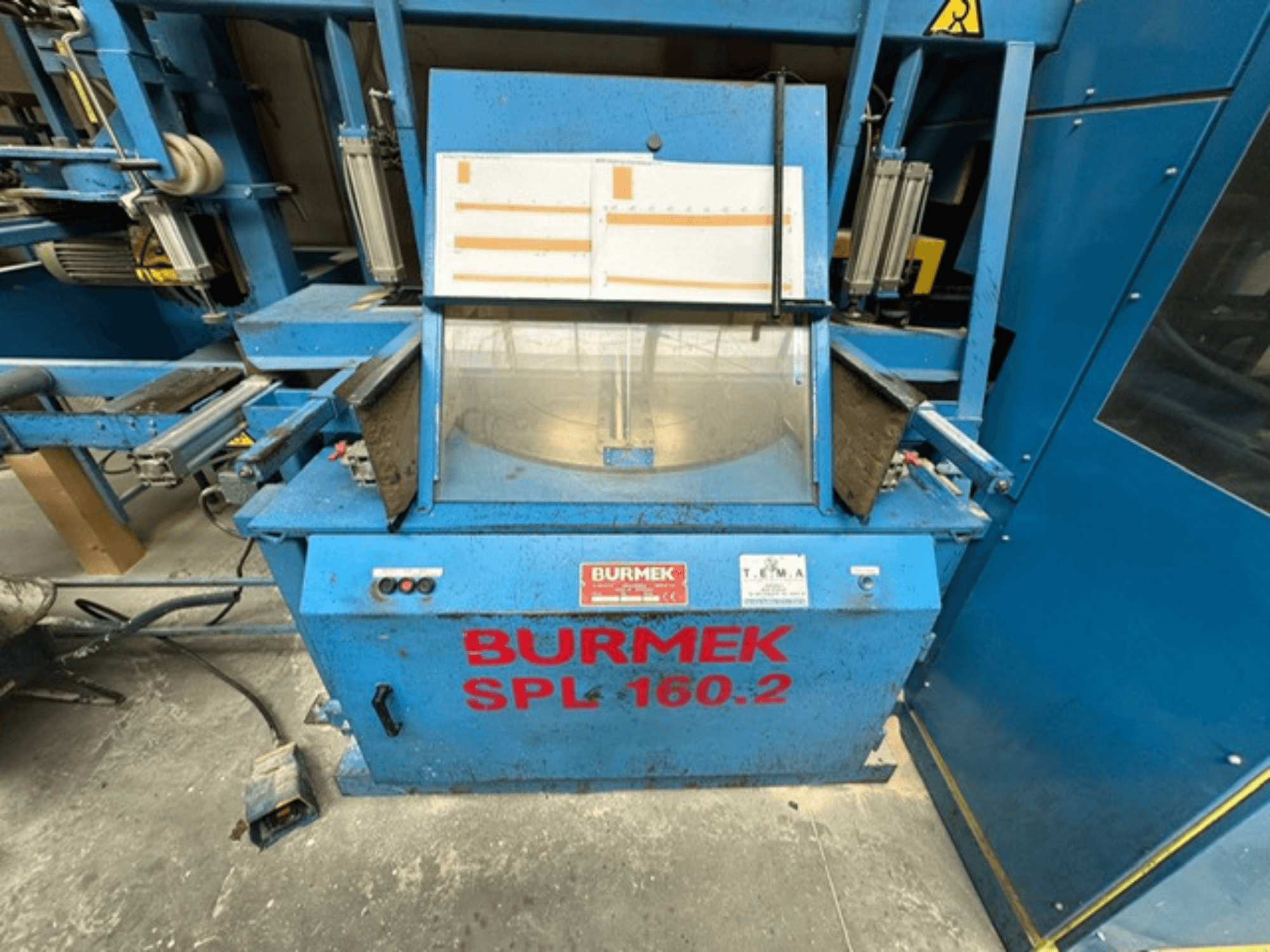 Blaue Holzmaschine BURMEK SPL 160.2, Frontansicht mit Bedientasten und Glasscheibe, die das Innere der Maschine zeigt.