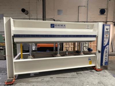 Hydraulische Presse der ORMA-Maschinen, Vorderansicht, mit silberner Oberfläche, Bedienpult rechts und aufrechten Presskolben.