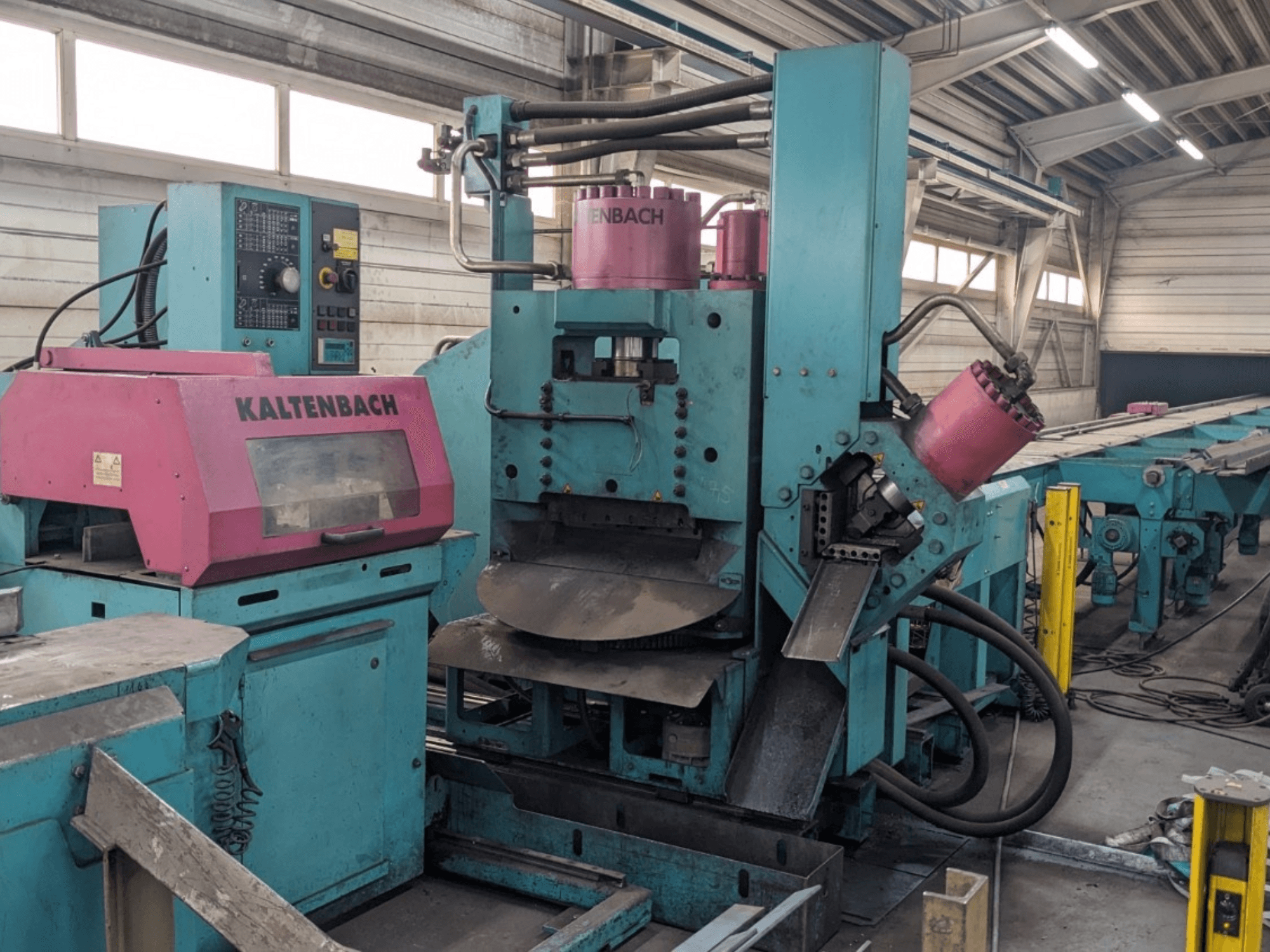 KALTENBACH-Industriemaschine in Petrol und Rosa, Vorderansicht, mit Bedienfeld und Hydraulikkomponenten.
