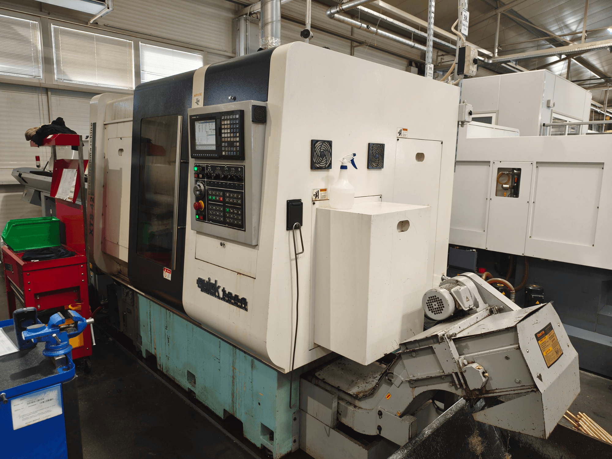 Vorderansicht der Horizontal-Drehmaschine Quick-Tech XTS-42 mit Bedienfeld und Kühlmittelbehälter.