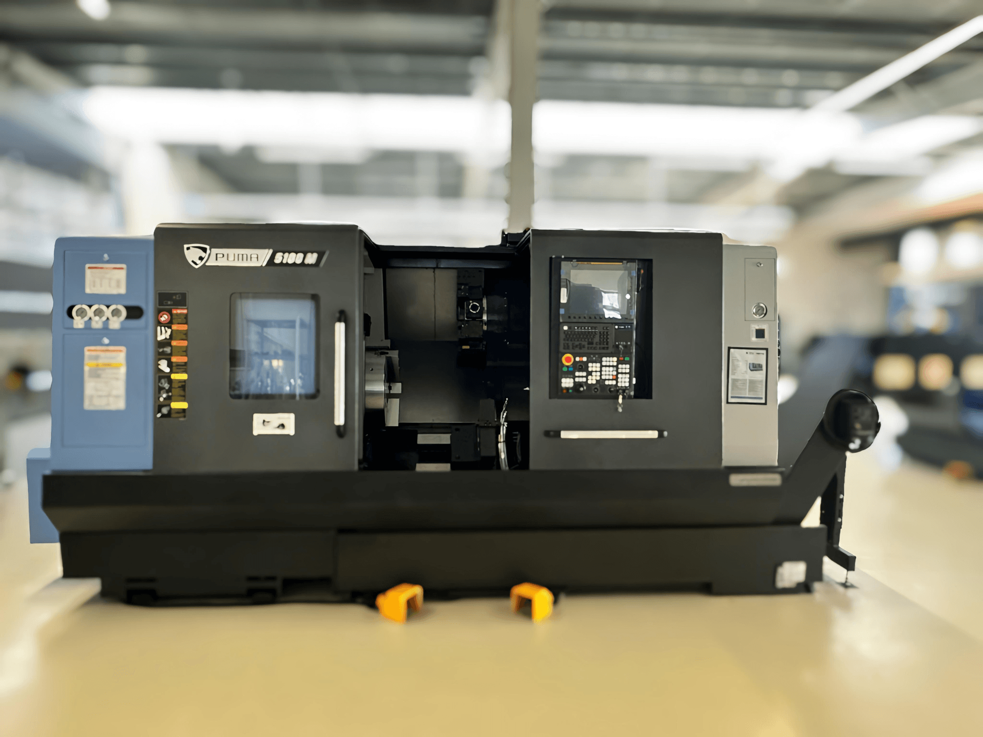 Frontansicht des DN SOLUTIONS PUMA 5100 MB Dreh-Fräszentrums mit Bedienfeld und Bearbeitungsbereich.
