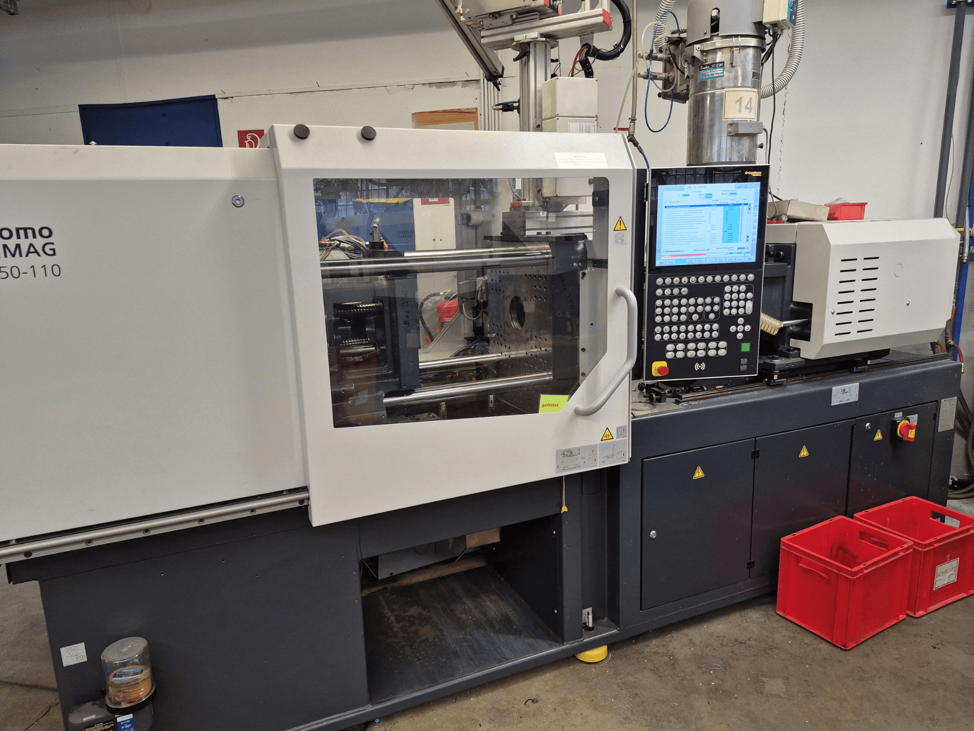 Elektrische Spritzgießmaschine SUMITOMO SHI DEMAG Intelect 2 50/360-110, Seitenansicht mit sichtbarem Bedienfeld und Sicherheitsvorrichtungen.