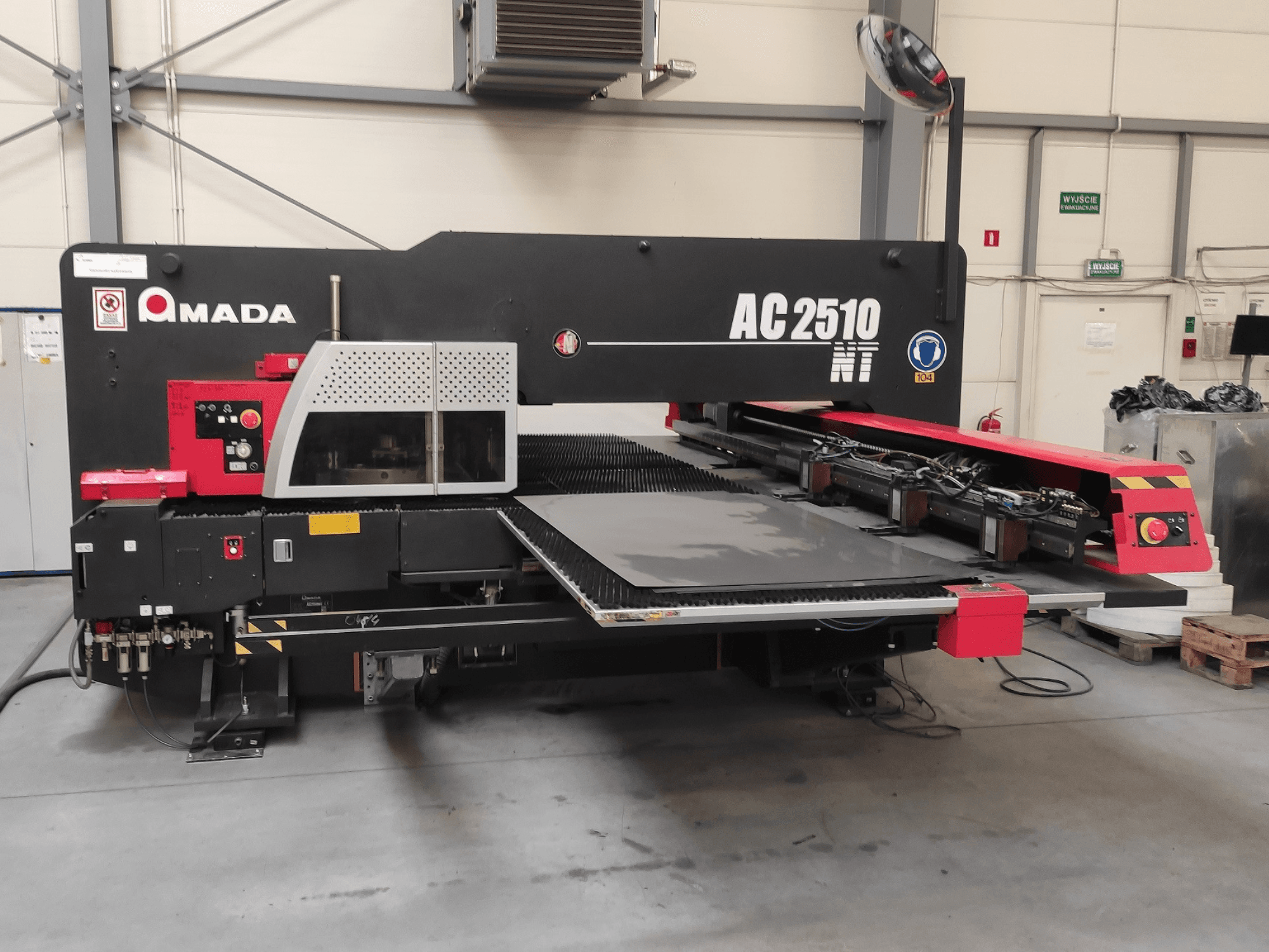 Amada AC2510 NT CNC-Stanzmaschine, Vorderansicht, mit Bedienfeld und Blechladebereich.
