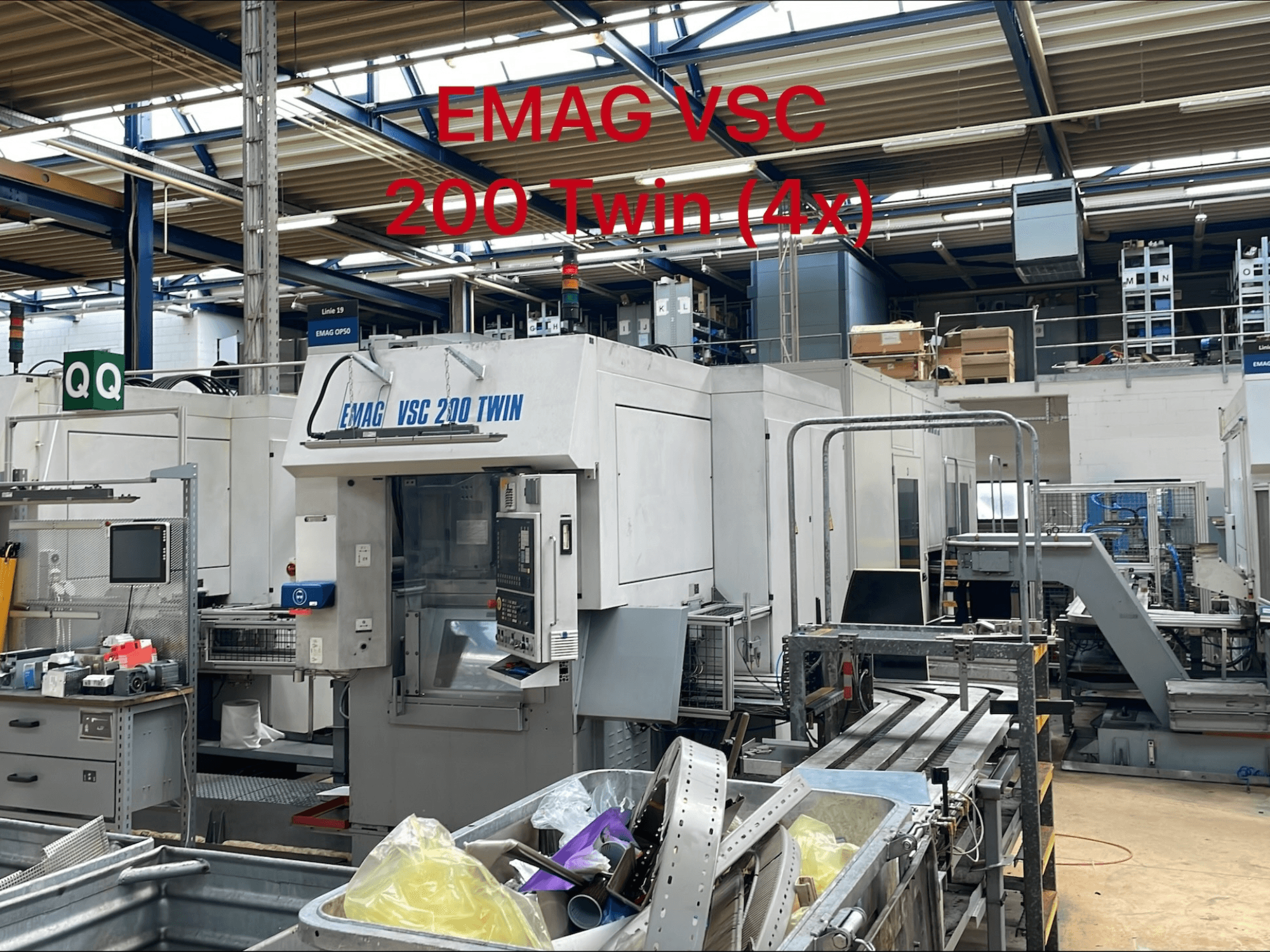 EMAG VSC 200 TWIN Vertikaldrehmaschine in einer Werksumgebung, Vorderansicht mit Bedienelementen und Werkzeugablagefläche.