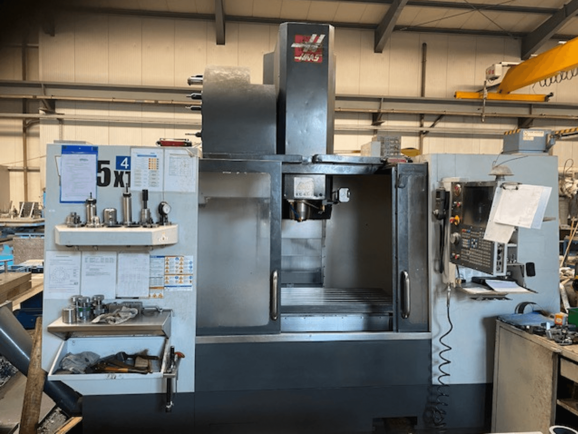 Haas VF-5 Vertikal-Bearbeitungszentrum, Vorderansicht, mit Bedienfeld, Werkzeugspeicher und Spindelbereich.