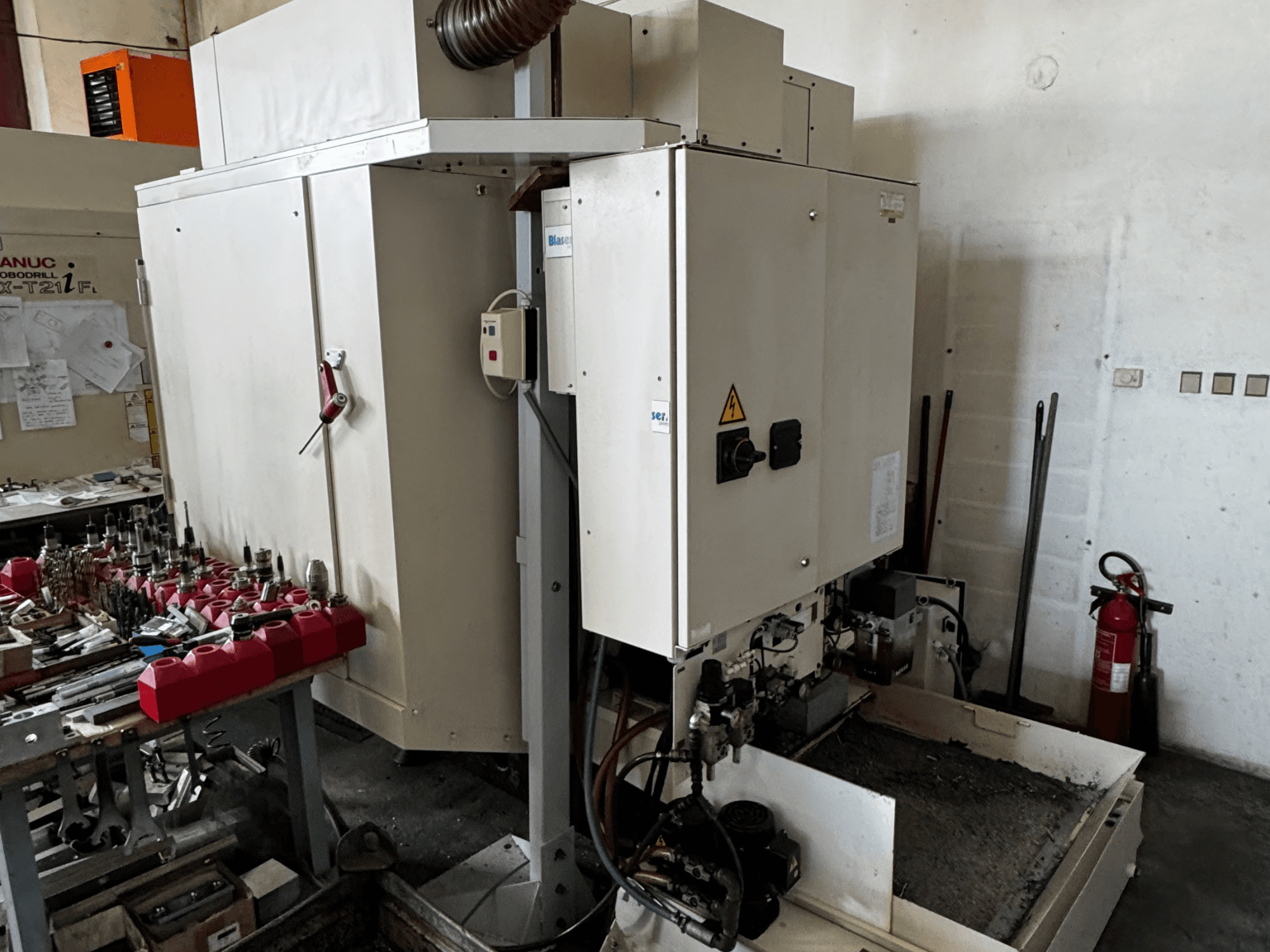 FANUC Robodrill alpha-T21iFL vertikales Bearbeitungszentrum, Seitenansicht mit Bedienfeld, Werkzeugen und Arbeitsbereich.