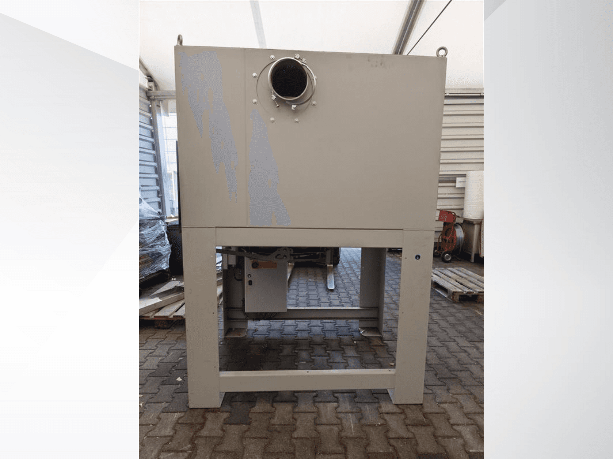 Grauer Industriestaubabscheider von vorne gesehen, mit großer runder Öffnung und auf einem stabilen Sockel montiert.