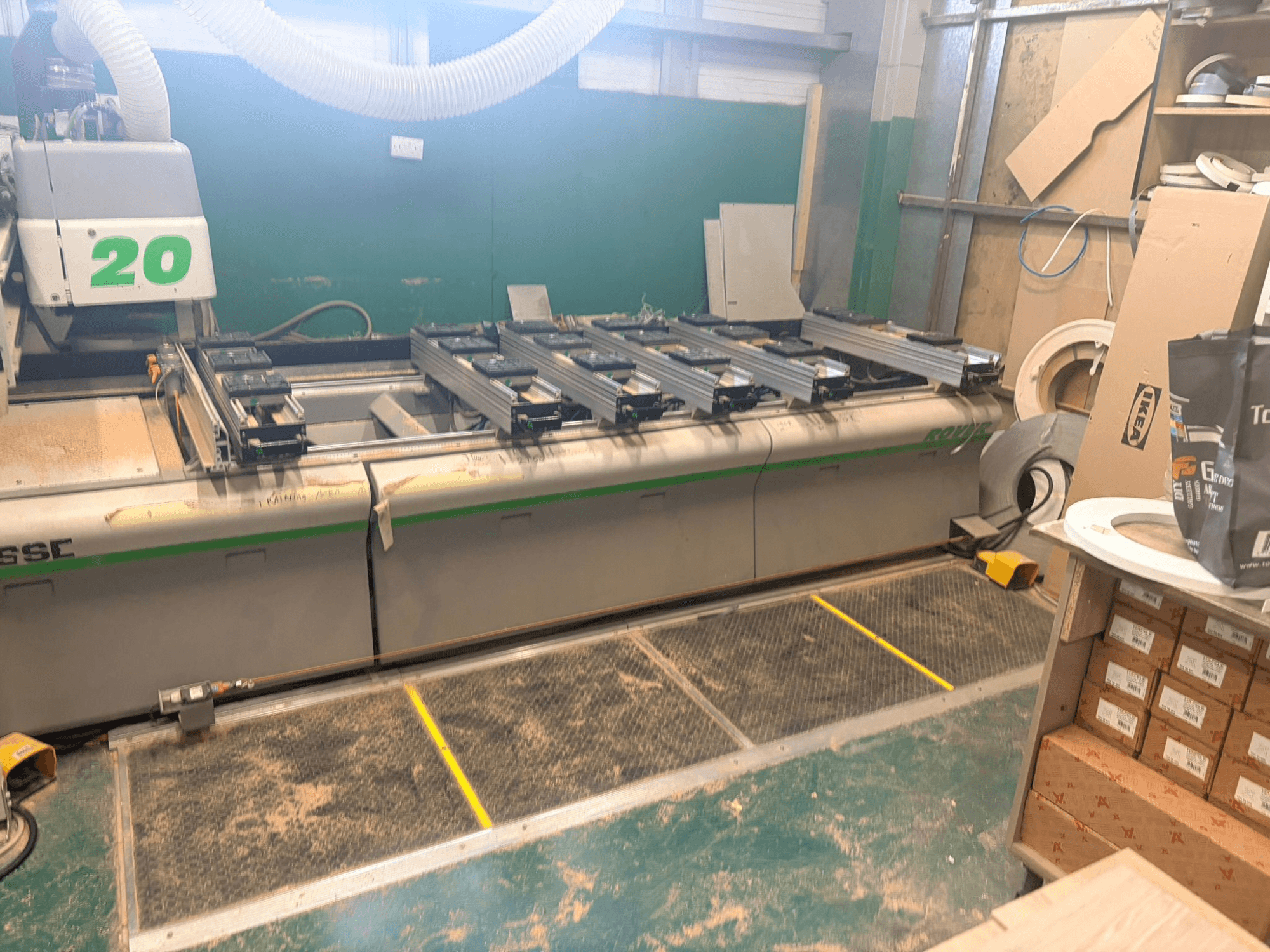 CNC-Holzbearbeitungszentrum BIESSE ROVER 20, Vorderansicht, mit Schienensystem, Bedienelementen und sichtbaren Sägespänen auf der Oberfläche.