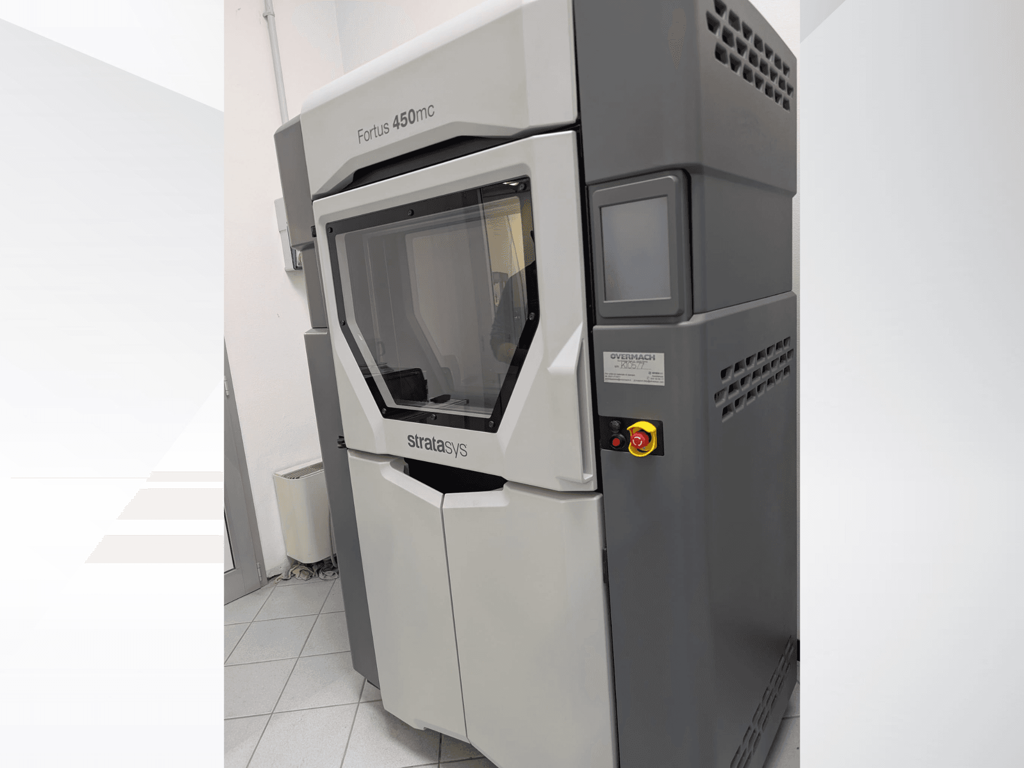 Der Fortus 450mc 3D-Drucker aus Kunststoff in der Seitenansicht, mit durchsichtiger Frontplatte und seitlichen Bedientasten.