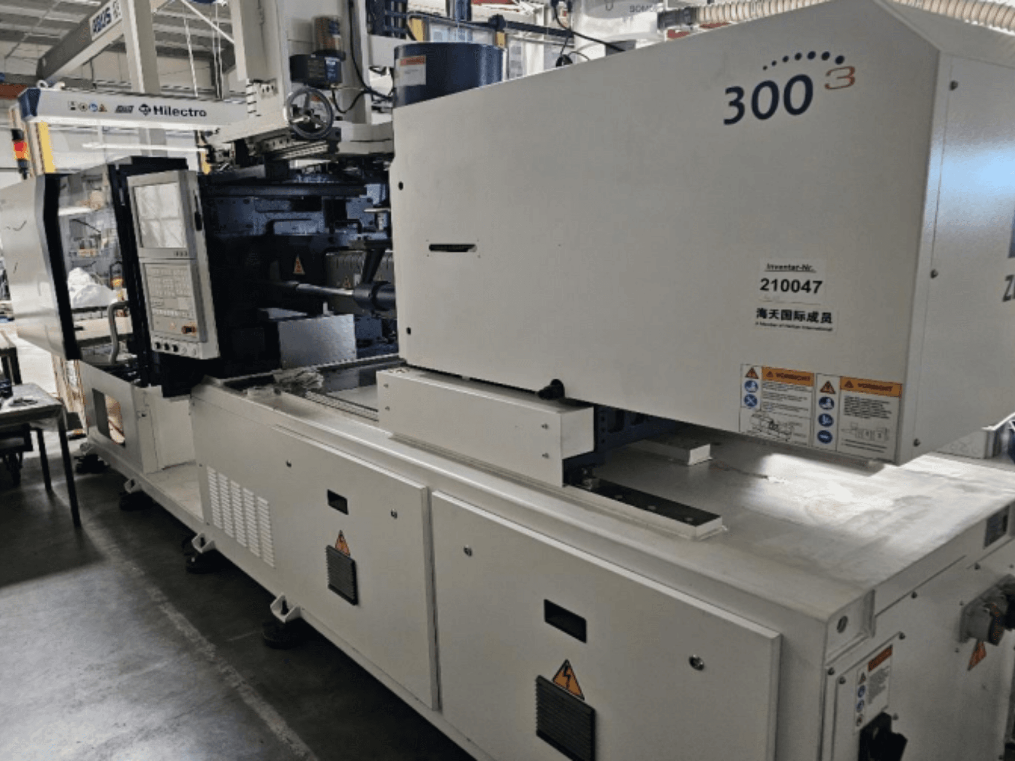 Spritzgießmaschine, Marke Zhenjing, Modell 300, Vorderansicht mit Bedienfeld und Sicherheitswarnschildern.