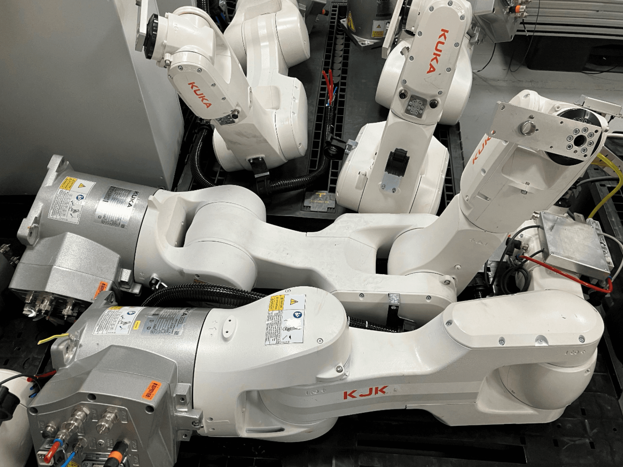 KUKA KR 10 R900 CR Roboterarm in einer Seitenansicht, die die Gelenkstruktur, die Motoren und die Verkabelungsdetails zeigt.