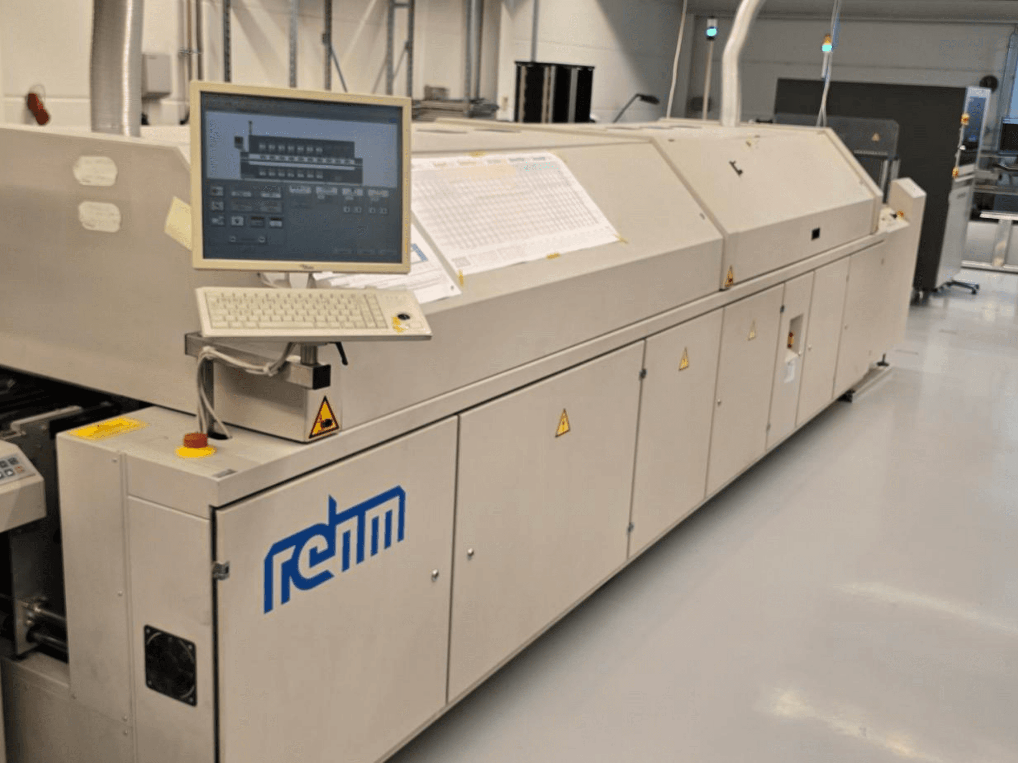 REHM VXS nitro 2450 Automatisierungsanlage, Vorderansicht; umfasst Monitor, Tastatur und Bedienfeld für den Betrieb.