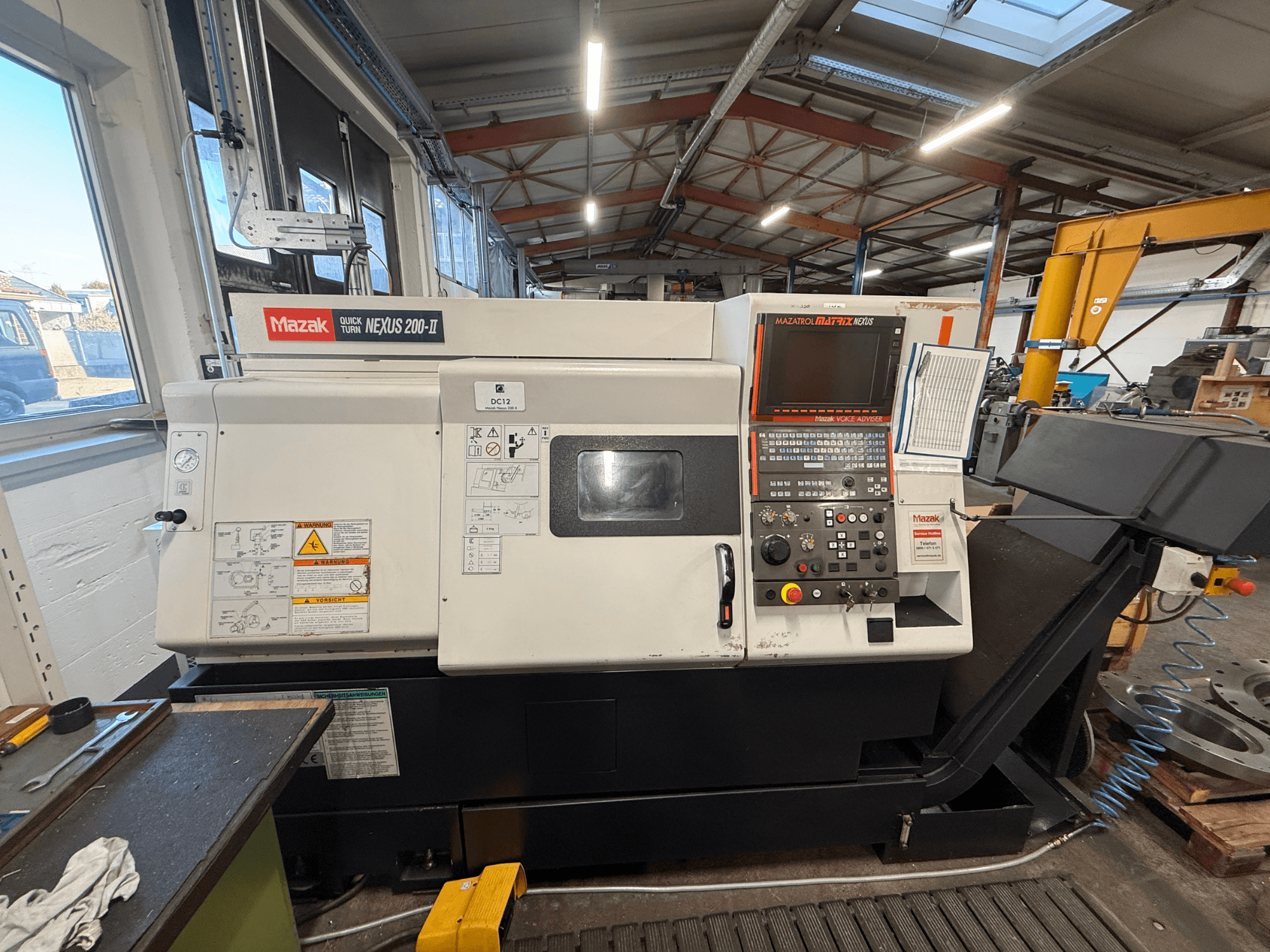 Horizontaldrehmaschine Mazak QUICK TURN NEXUS 200-II, Vorderansicht, mit Blick auf das Bedienfeld und die Bedienelemente.
