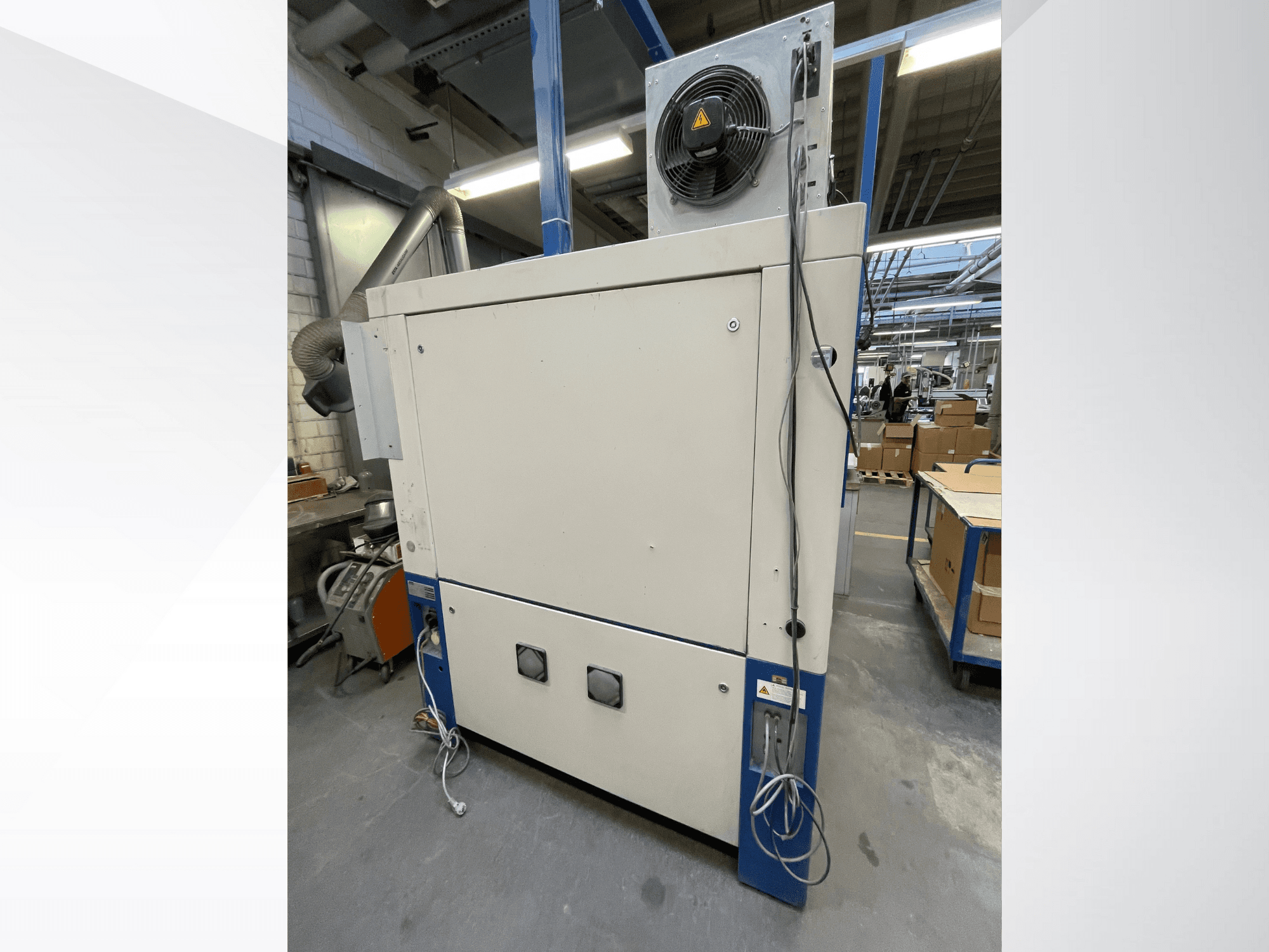 Industrielle Trocknungsmaschine mit Ventilator, Seitenansicht; mit Belüftung und mehreren elektrischen Anschlüssen. Marke/Modell nicht sichtbar.